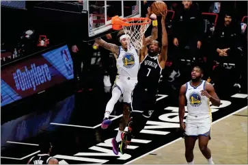  ?? AP PHOTO BY KATHY WILLENS ?? Brooklyn Nets forward Kevin Durant (7) shoots as Golden State Warriors forward Kelly Oubre Jr. (12) defends with Golden State Warriors forward Eric Paschall (7) looking on from the floor during the first quarter of an opening night NBA basketball game, Tuesday, Dec. 22, in New York.