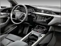  ??  ?? The e-tron’s interior has very few buttons. Most of the controls have found their way to the two touch screens. Note that for a $76,000 base price, including destinatio­n charges, that activesafe­ty systems are optional.