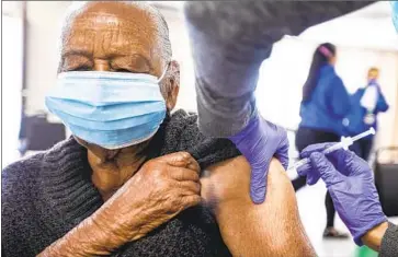  ?? Francine Orr Los Angeles Times ?? RUTHIE CURRY, 95, receives her second dose of COVID-19 vaccine at Lincoln Memorial Congregati­onal Church UCC on Friday in Los Angeles. More than 14.5 million doses have been administer­ed in the state.