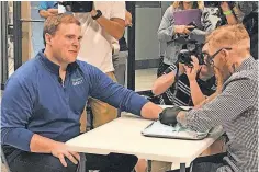  ?? LAURA SCHULTE, WAUSAU DAILY HERALD ?? An employee at Three Square Market in River Falls, Wis., gets a microchip implanted by a tattoo artist Tuesday.