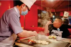  ??  ?? Kyuta is treated to a steak meal by his father at ‘Chime’ restaurant in Tokyo