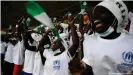  ?? ?? Girls from the Minawao Refugee Camp celebrate at the Nigeria and Sudan game