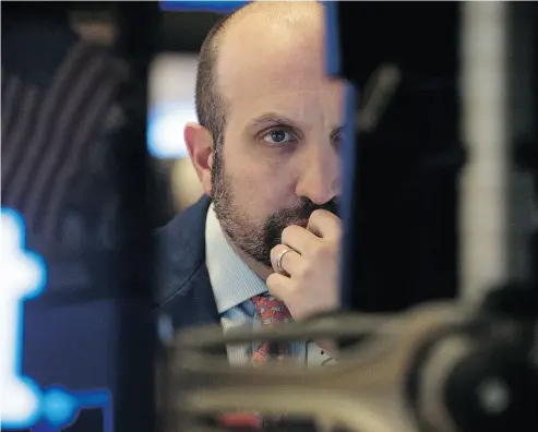  ?? BRYAN R. SMITH / AFP / GETTY IMAGES ?? Traders work on the floor at New York Stock Exchange, where U. S. markets are benefiting from a confident investor base eager to buy on market dips and sell offs, Martin Pelletier writes.