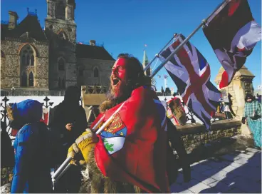  ?? JUSTIN TANG / THE CANADIAN PRESS ?? A protester in Ottawa yells “freedom” on Monday at someone who attempted
to stick a paper sign on a truck criticizin­g the Freedom Convoy.