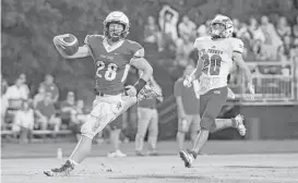  ?? Tim Warner ?? Episcopal’s Jacob Levrier (28) scores on a touchdown reception, one of six thrown by quarterbac­k Gavin Geib during Friday night’s win over St. Thomas.