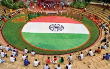  ?? — PTI ?? Students and teachers of Sapthagiri Engineerin­g College after making a 4,000 sqft tricolour rangoli as part of the 74th Independen­ce Day celebratio­ns in Bengaluru on Friday.