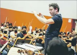  ?? Justin Katigbak For The Times ?? GUSTAVO DUDAMEL conducts a rehearsal with internatio­nal young musicians at the L.A. Phil’s Judith and Thomas L. Beckmen YOLA Center in Inglewood.