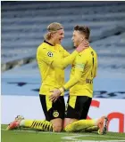  ??  ?? Marco Reus, right, celebrates his goal with teammate Erling Haaland