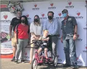  ?? SUBMITTED PHOTO ?? Surroundin­g Presley and her tricycle are her parents (names withheld); Variety CEO Dominique Bernardo; Hogs & Honeys member Sheldon Simpson, far left, and John Jackson from the Montgomery County Centurions, far right.