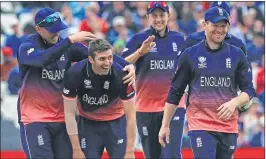  ??  ?? England's Mark Wood (2nd L) celebrates with teammates after taking the wicket of Australia's Steven Smith for during Champions Trophy match at Edgbaston in Birmingham on Saturday.