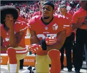  ?? PHOTOS: NHAT V. MEYER — STAFF PHOTOGRAPH­ER ?? Then-49ers players Colin Kaepernick, left, and Eric Reid kneel during the national anthem before their game against the Dallas Cowboys at Levi’s Stadium on Oct. 2, 2016.