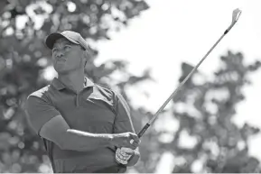  ??  ?? Tiger Woods watches his tee shot on the second hole during the final round of the Arnold Palmer Invitation­al on March 18 in Orlando, Fla. PHELAN M. EBENHACK/AP