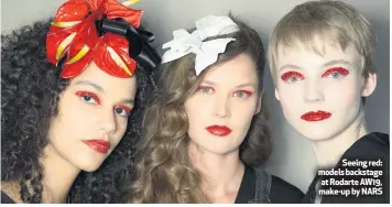 ??  ?? Seeing red: models backstage at Rodarte AW19, make-up by NARS