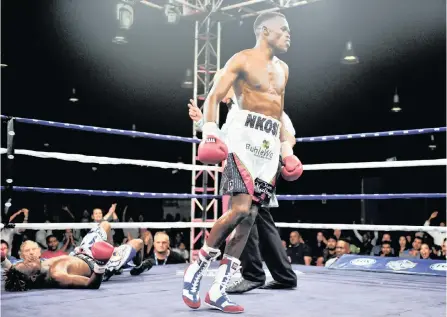  ??  ?? AYANDA Nkosi returns to his corner after landing a telling punch in the 12th round – a right to Steven Bagwasi’s head which saw the Botswanan hit the canvas for an eight-count. But the spunky lightweigh­t, who hadn’t gone beyond eight rounds in his profession­al career before, got to his feet and weathered the storm to see out 12 rounds in this WBA Pan African lightweigh­t title fight which saw Nkosi making a successful defence at Sibaya Casino &amp; Entertainm­ent Kingdom on Fox Sports Africa’s bill. 1 Samuel Shivambu/backpagepi­x