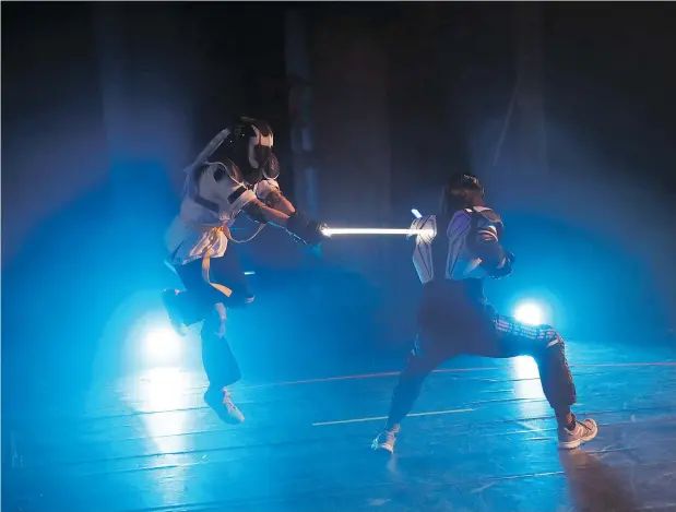  ?? — CHRISTOPHE ENA/THE ASSOCIATED PRESS FILES ?? Competitor­s battle during a national lightsabre tournament in Beaumont-sur-Oise, north of Paris.