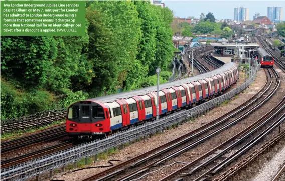  ?? DAVID JUKES. ?? Two London Undergroun­d Jubilee Line services pass at Kilburn on May 7. Transport for London has admitted to London Undergroun­d using a formula that sometimes means it charges 5p more than National Rail for an identicall­y-priced ticket after a discount is applied.