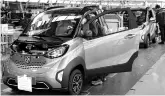  ??  ?? Baojun E100 electric cars at an assembly plant operated by General Motors in China