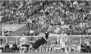  ?? BERNAT ARMANGUE/ THE ASSOCIATED PRESS ?? Netherland­s Robin van Persie goes airborne for a goal during the World Cup match against Spain.