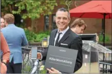  ?? RECORD FILE PHOTO ?? In this file photo, Troy restaurate­ur and ride-hailing advocate Vic Christophe­r holds up a #UberMovesA­lbany sign at a ride-hailing launch news conference in downtown Albany.