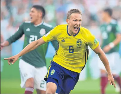  ?? HECTOR RETAMAL — AFP/GETTY IMAGES ?? Sweden defender Ludwig Augustinss­on celebrates after scoring the opening goal of a 3-0 group F victory over Mexico on Wednesday.