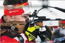  ?? GREGORIO BORGIA/THE ASSOCIATED PRESS ?? Calgary’s Christian Gow shoots during the men’s 4x7.5-kilometre biathlon relay.