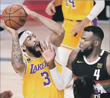  ?? Mark J. Terrill Associated Press ?? ANTHONY DAVIS GOES UP strong against Denver’s Paul Millsap during the f irst half of the Lakers’ win in Game 4. Davis scored the Lakers’ f irst 10 points and wound up as the game’s leading scorer with 34.