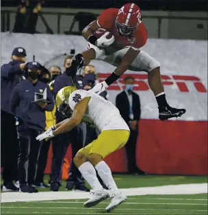  ?? MICHAEL AINSWORTH — THE ASSOCIATED PRESS ?? Alabama running back Najee Harris (22) hurdles Notre Dame cornerback Nick McCloud (4) as he carries the ball for a long gain in the first half of the Rose Bowl on Friday in Arlington, Texas.