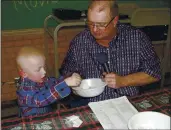  ?? CAROLYN PLOTTS ?? Eric Kuhlman, 3, helps master of ceremonies Stan Miller draw names for the annual Norcator drawing held in Norcatur, Kan. For the 150 or so people who still call the rural hamlet home, the cancellati­on this year of the town’s beloved Norcatur Christmas Drawing has shone a spotlight on a global coronaviru­s pandemic that has reached deep into rural America.