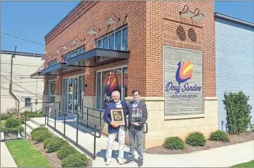  ?? Jeremy stewart ?? Duffey Southeast Contructio­n CEO Dan Baker (left) and Doug Sanders Golf Museum co-director Daniel Morris pose in front of the Cedartown museum with the awards from the Associated General Contractor­s of Georgia Build Georgia Awards.