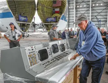  ?? Photos by Steve Gonzales / Staff photograph­er ?? James Franco of Kansas-based Cosmospher­e takes plastic wrap off the first group of restored historic Mission Control consoles, which helped land humans on the Moon.