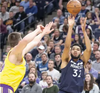  ?? BRACE HEMMELGARN-USA TODAY SPORTS ?? MINNESOTA TIMBERWOLV­ES center Karl-Anthony Towns (32) shoots during the fourth quarter against the Los Angeles Lakers at Target Center.