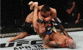  ??  ?? Charles Oliveira attempts to secure a triangle choke against Kevin Lee in the main even of the UFC Fight Night card on Saturday in Brasilia. Photograph: Buda Mendes/Zuffa LLC