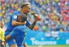  ?? THE ASSOCIATED PRESS ?? Brazil’s Neymar, top, celebrates with teammate Douglas Costa after scoring the second goal of a 2-0 win against Costa Rica in a World Cup Group E match Friday in St. Petersburg, Russia. Both of Brazil’s goals came during stoppage time.