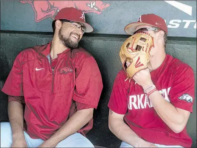  ?? NWA Democrat-Gazette/BEN GOFF ?? Arkansas pitcher Isaiah Campbell (left) and third baseman Casey Martin clown around in the dugout Thursday during practice at Baum Stadium in Fayettevil­le. The Razorbacks open the NCAA Fayettevil­le Regional at 2 p.m. today against Oral Roberts.