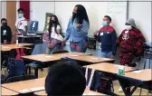  ?? ALI TADAYON — EDSOURCE ?? Dorcas Sims leads her fifth grade class at Richmond’s Nystrom Elementary in a circle activity in which students said their names accompanie­d by a gesture, which the rest of the class would then repeat.