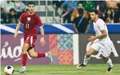  ?? ?? Abdulla al-Yazidi, who scored Qatar’s opening goal, vies for the ball with Jordan’s Mohannad Abu Taha yesterday.