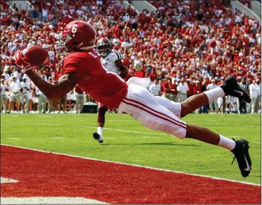  ?? Associated Press ?? In for six: In this Sept. 22, 2018, file photo, Alabama wide receiver DeVonta Smith (6) catches a pass for a touchdown during the first half of an NCAA college football game against Texas A&amp;M in Tuscaloosa, Ala. No. 1 Alabama has one of the SEC's most talented collection of receivers, and the Crimson Tide is spreading it around among Jerry Jeudy, Henry Ruggs III, Jaylen Waddle and Smith.