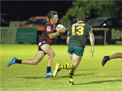  ?? Photo: Nev Madsen ?? BREAKING FREE: Valleys fullback Dylan Chown attempts to bust through the Wattles defensive line during their 34-12 victory over the Warriors on Saturday night at Herb Steinohrt Oval.