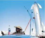  ??  ?? JB Wagoner of Los Angeles takes selfies of his agave spirit Temequila with the Starship in the background.