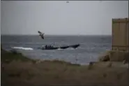  ?? EMILIO MORENATTI — THE ASSOCIATED PRESS ?? A speedboat with boxes of alleged drug cargo onboard sails along the coast of La Linea de la Conception, in Cadiz province, south of Spain. Spain’s neglected southern corner is reeling under an escalating war between authoritie­s and crime gangs who...