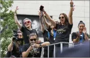  ?? CRAIG RUTTLE - THE ASSOCIATED PRESS ?? Members of the U.S. women’s soccer team, including Megan Rapinoe, rear left, and Alex Morgan, right foreground, stand on a float before being honored with a ticker tape parade along the Canyon of Heroes in New York, Wednesday, July 10, 2019.