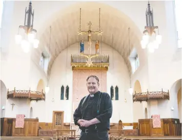  ?? RICHARD LAM/POSTMEDIA ?? Anglican clergyman Father Matthew Johnson stands inside St. James Church. He has returned to limited street ministry while wearing a mask.