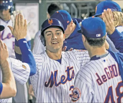  ?? Anthony J. Causi ?? THE ONE AND ONLY: Michael Conforto is congratula­ted by his teammates after slugging a home run in the sixth inning for the Mets’ only run in an eventual 7-1, 14-inning loss to the Cubs on Saturday night at Citi Field.