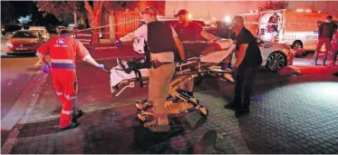  ?? | LEON KNIPE ?? PARAMEDICS transport a shooting victim in Milnerton.