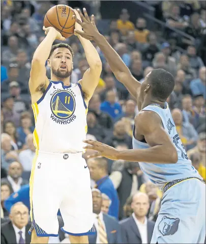  ?? JANE TYSKA — STAFF PHOTOS ?? The Warriors’ Klay Thompson shoots over Memphis’ Jaren Jackson Jr. en route to a team-high 27 points in the win Monday night.