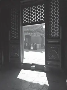  ?? Thomas Huang/Dallas Morning News/TNS ?? ■ A threshold at the Yonghe Temple in Beijing provides a play of shadow and light.