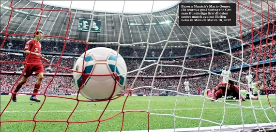  ??  ?? Bayern Munich's Mario Gomez (R) scores a goal during the German Bundesliga first division soccer match against Hoffenheim in Munich March 10, 2012.