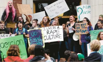  ?? CHRIS PIETSCH/THE REGISTER-GUARD ?? University of Oregon students and staff protest May 8 on campus in Eugene, Oregon, against sexual violence in the wake of allegation­s of rape brought against three UO basketball players by a fellow student.