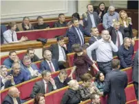  ?? — AFP ?? Ukrainian lawmakers react after voting bill for stripping lawmakers of immunity from prosecutio­n in Kiev on Thursday.