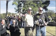  ?? YALONDA M. JAMES/THE COMMERCIAL APPEAL ?? A mix of onlookers see David Spencer of West Tennessee Veterans Home Motorcycle accept a donation from Bob Antis of Combat Veterans Motorcycle Associatio­n Tenn. Chapter 18-6.